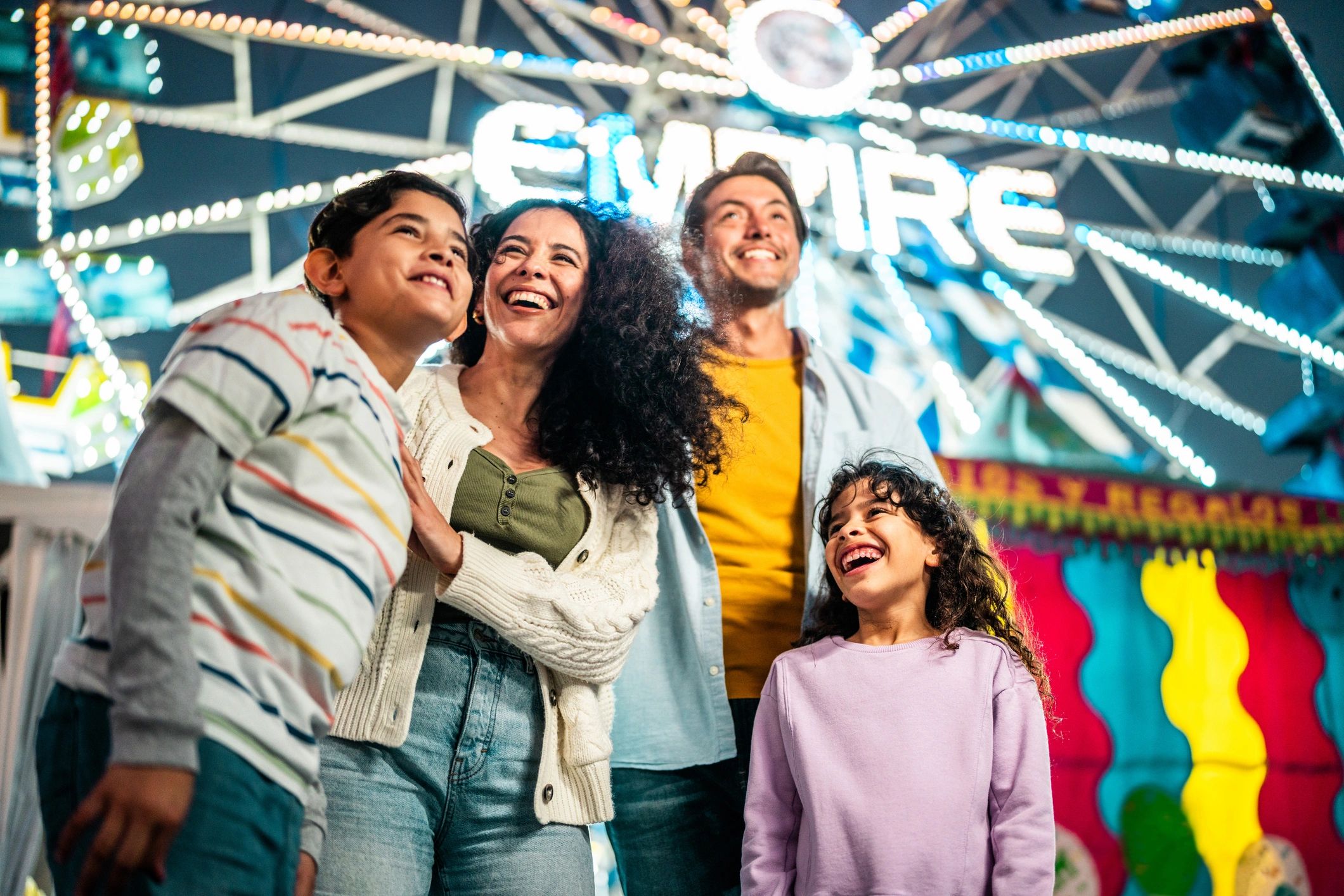 Family talking at an amusement park